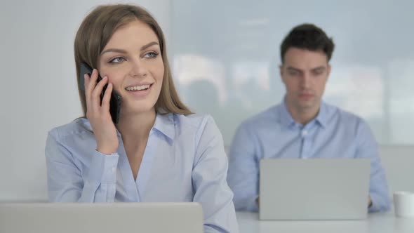 Young Businesswoman Talking on Phone Discussing Work