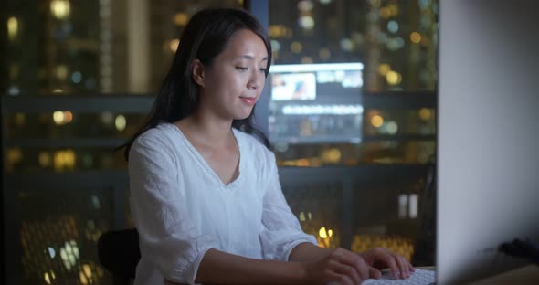 Woman work on computer at night