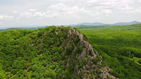 The Cross is Located at the Top in the Middle of a Green Valley