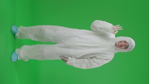 Full Body Of Man Wear Protective Uniform Ppe And Showing Hand Ok Sign In The Green Screen Studio