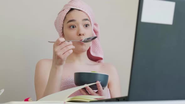 Business Lady with a Towel on Head Eating Healthy Breaksfast and Talking Online