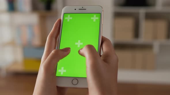 Closeup of hand woman typing smartphone with green screen