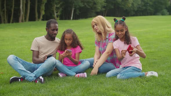 Diverse Family with Girls Taking Selfie in Park