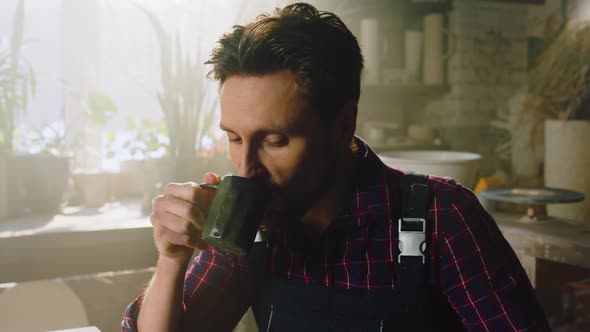 Young Busy Man Is Drinking Coffee