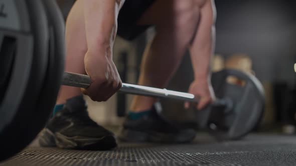 Handheld Anonymous Athletic Man is Preparing to Lift a Barbell Weights Training in the Gym Lower