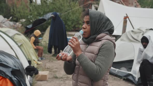 Homeless Girl Drinking Water