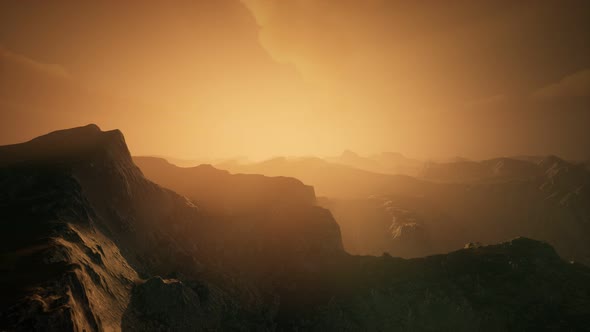 High Mountain Peaks Covered with Dramatic Heavy Fog alt