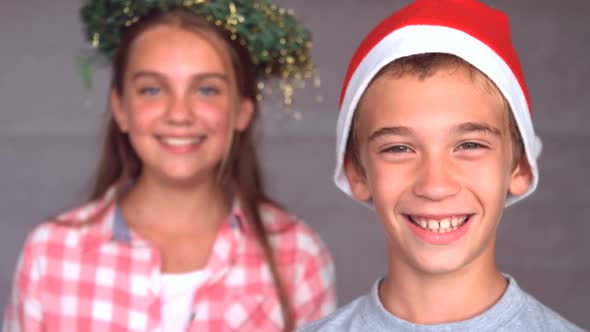 Smiling siblings with christmas hat