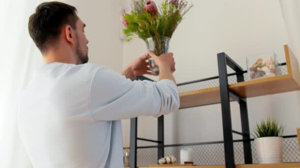 Man Decorating Home with Flower or Houseplant