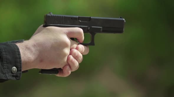 Close-up Shot of a Pistol. Slow Motion.