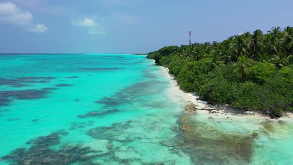 Aerial view seascape of tropical resort beach break by turquoise lagoon and white sand background of