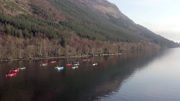 A Team of Canoeists Traversing a Lake in the Early Morning