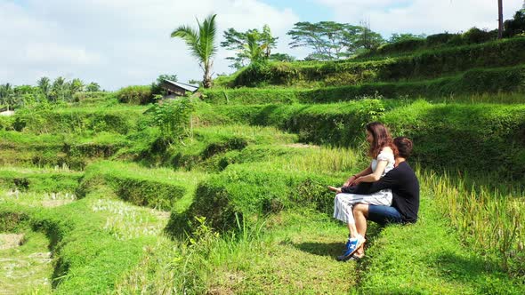 Romantic Couple Having Fun in The Banaue Rice Terraces in the Philippines With Green Trees In the Ba