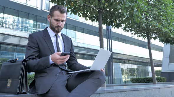 Businessman Using Smartphone for Work Outside Office