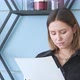 A woman looks at documents in her office. She does her own business - VideoHive Item for Sale