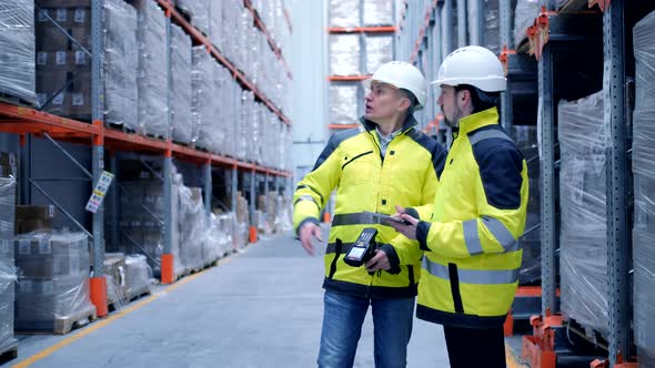 Worker male warehouse worker engineer man in a helmet working on the construction site