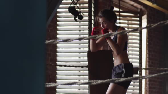 Female Boxer in Sportswear Practicing Shadow Boxing