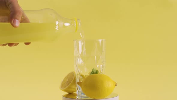 Preparing serving lemonade in glass glass.