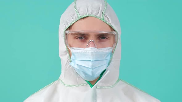 Man in Protective Suit Medical Mask and Goggles Looking at Camera