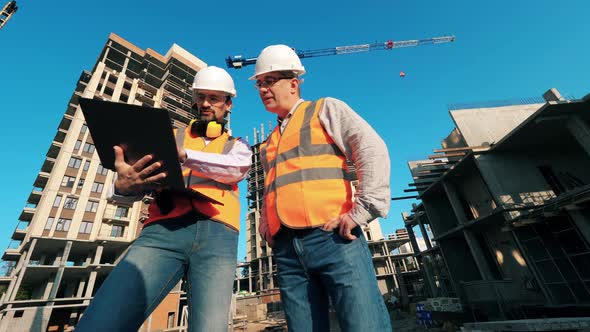 Male Engineers Are Operating a Laptop at the Construction Yard