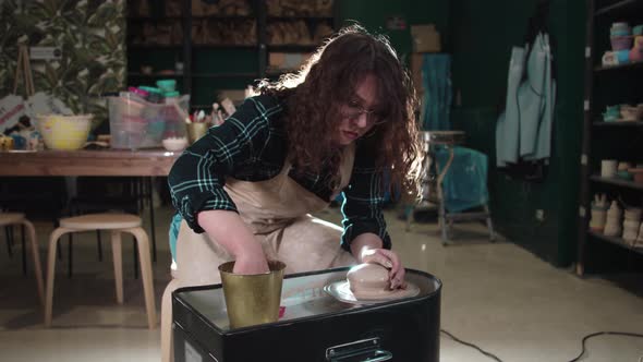 Pottery Crafting  Young Woman with Curly Hair Working with Wet Clay