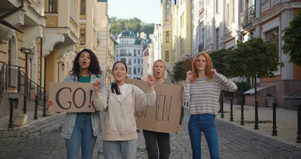 Outdoor Portrait of Women Activists Protest with Go Woman Posters