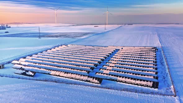 Alternative energy in winter. Snowy photovoltaic farm.