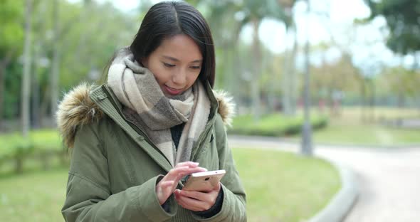 Woman use of mobile phone at park