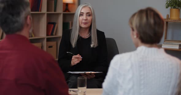 Female Psychologist Helping Worried Young Couple