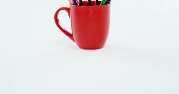 Colored pencils kept in red mug