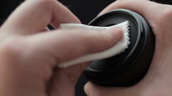 A Photographer Cleans Camera Lens with a Soft Cloth