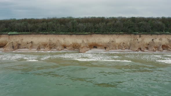 Aerial View of Sea Waves Beating Against a Rocky Shore on a Sandy Tropical Beach