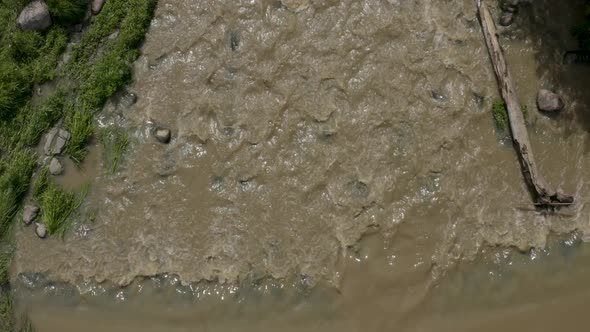 Top down aerial view of a muddy Keravanjoki River near Kerava, Finland.