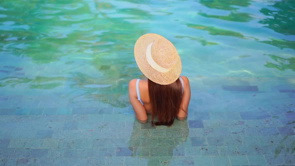 Young asian woman enjoy around outdoor swimming pool for leisure