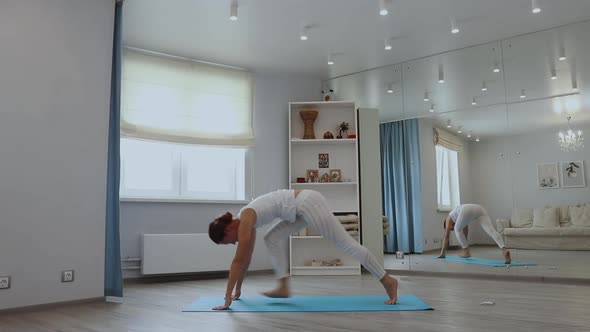 Young Woman Practicing Yoga in Studio