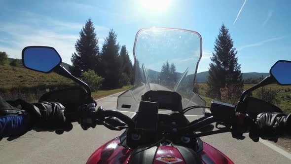 POV Biker Rides on Motorbike By Scenic Sunny Mountain Road on Plateau in Croatia