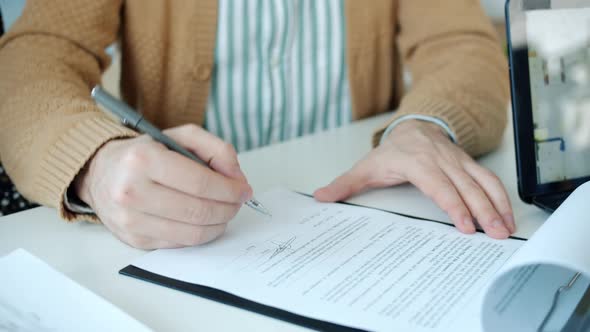 Male Hand Signing Real Estate Deal Taking Key From Realtor Shaking Hands Hugging Wife