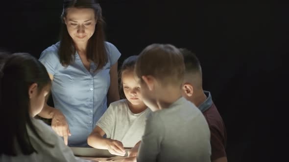 Woman and Group of Children Making Sand Art