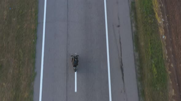 Aerial Shot of Motorcyclist Racing His Motorcycle on Country Road