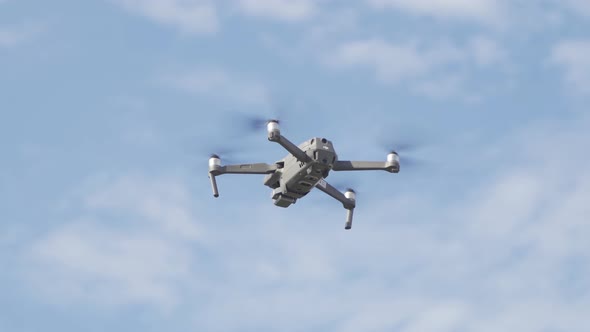 Aerial view of a professional drone with propellers flying with camera