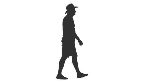 Silhouette of Adult Man Walking in Shorts and Cowboy Hat alt