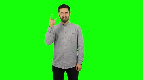 Brunette Guy Is Making a Rock Gesture and Enjoying Life. Green Screen