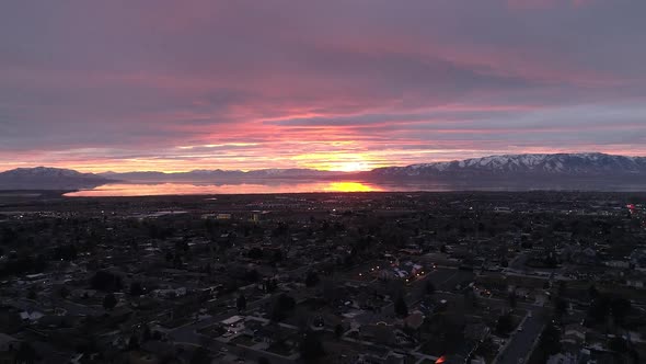 Aerial view flying backwards during colorful sunset in Utah