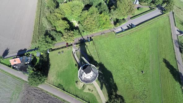 Aerial footage of windmill, drone lifting up.