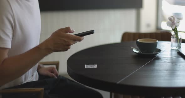 Closeup of Smartphone in Male Hands Tapping on Screen