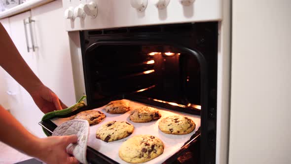 Girl Takes Out the Finished Cookies From the Oven