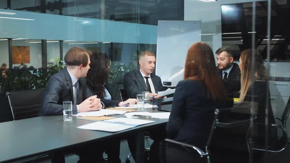 Team of Business People at Meeting in Office