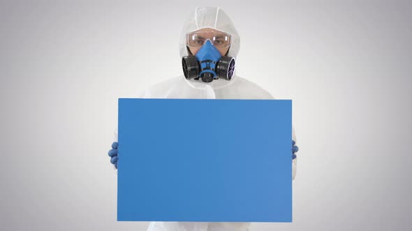 Male Doctor Wearing Protective Clothes Holding Blank Banner on Gradient Background