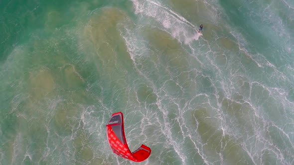 Aerial view of a man kitesurfing in Hawaii