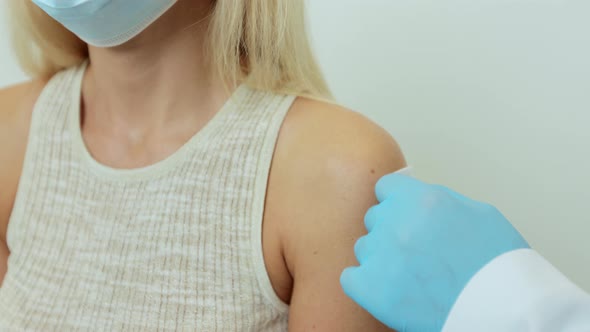 Woman Patient Getting Vaccine Injection in Hand at Hospital Close Up